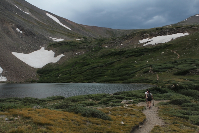 People on a trail passing by Silver Dollar Lake in Colorado