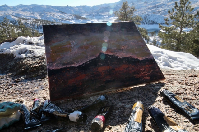 Painting and paints with a snowy canyon in the background