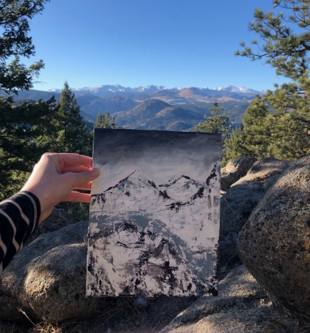 Blue, gray, and white painting with boulders and mountains