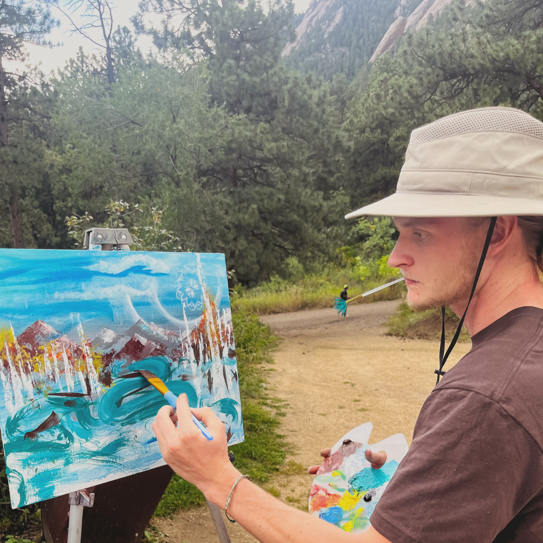 Community artist Eric Pflug painting at an Abstract Adventures hike & paint event